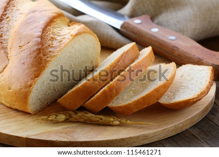 fresh white loaf of bread , rustic style