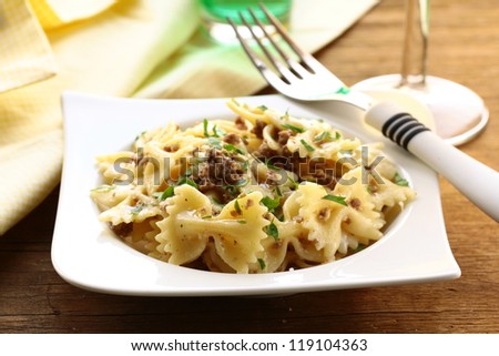 farfalle pasta with beef sauce  on  plate with  fork