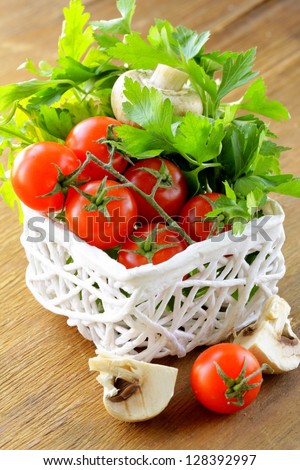 fresh vegetables  and herbs mix in a wicker basket