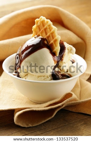 creamy vanilla ice cream with chocolate sauce and waffle