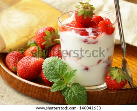 dairy dessert - yogurt with fresh strawberries in a glass