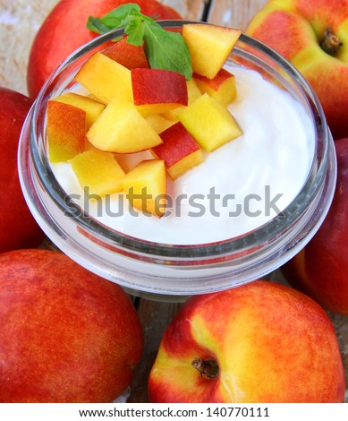 dairy yogurt with pieces of peaches in a glass jar