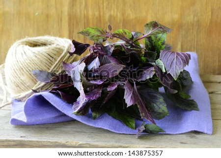bunch of purple basil on a wooden table