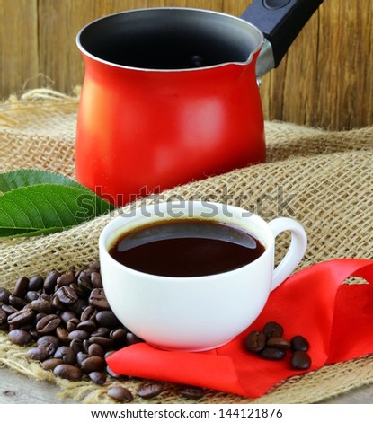 coffee beans and red coffee pot on a wooden table