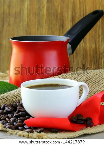 coffee beans and red coffee pot on a wooden table