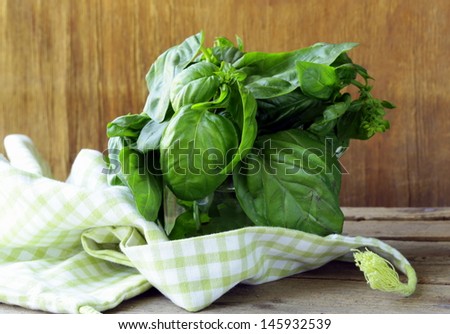bunch of fresh green basil on a wooden table