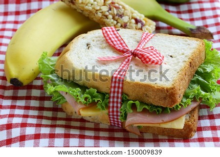 sandwich with ham, apple, banana and granola bar - healthy eating, school lunch