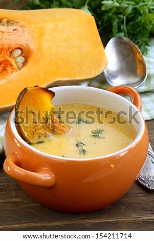 pumpkin cream soup with pieces roasted pumpkin and thyme