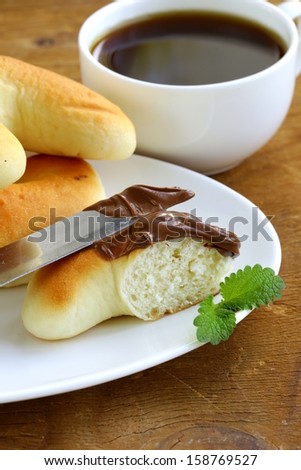 Chocolate nut paste (nutella) for breakfast with bread rolls