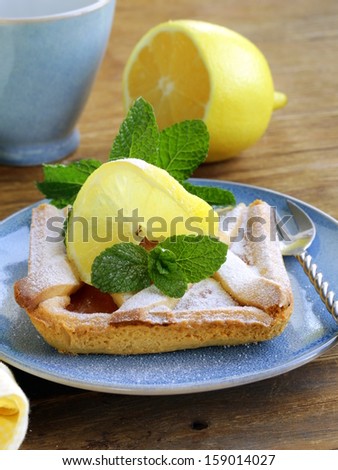 lemon pie with mint leaves and powdered sugar