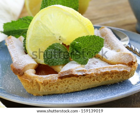 lemon pie with mint leaves and powdered sugar
