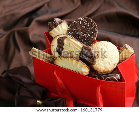 variety of cookies with chocolate and almonds in a gift package