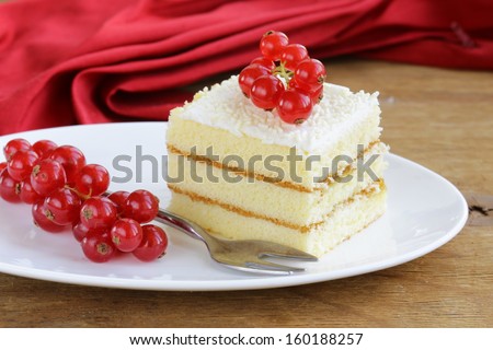 sponge cake with white chocolate, decorated with red currant