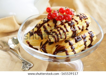 choux pastry eclairs on glass stand base, festive dessert