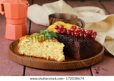 Assorted cake - chocolate and fruit on wooden plate