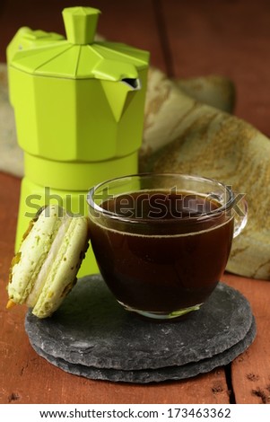still life cup of coffee (espresso) macaroon cookies and coffee maker