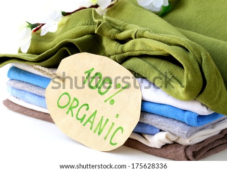 stack of multicolored clothing with 100% organic label