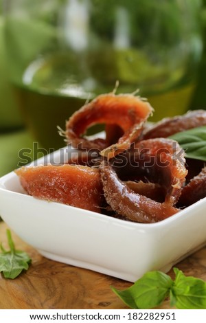 Canned marinated anchovies fillets in a white bowl
