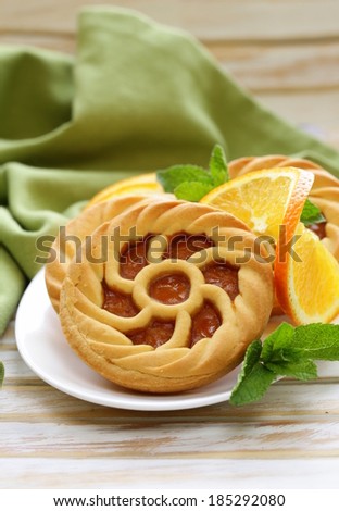 mini dessert tarts with orange on wooden table