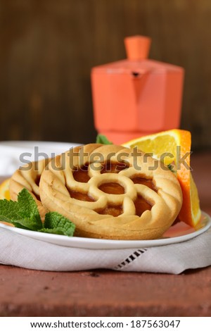 mini dessert tarts with orange on wooden table