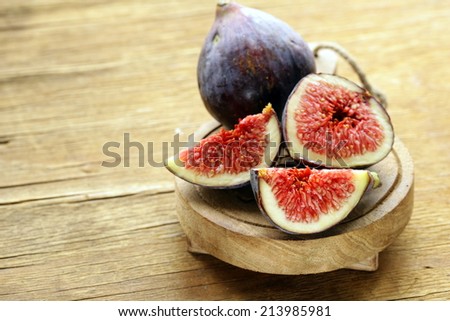 fresh ripe purple figs on wooden board