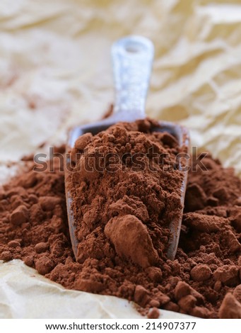 natural cocoa powder (chocolate) in a ceramic scoop