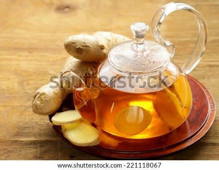 beverage tea with ginger and fresh root on a wooden background