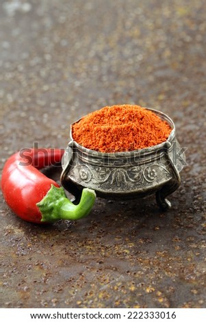 red spice paprika pepper on iron old background
