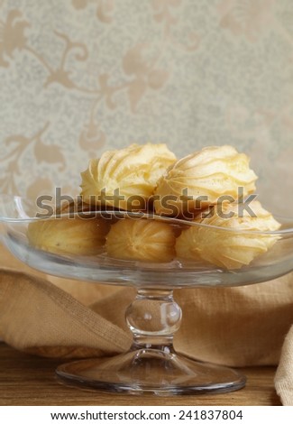 choux pastry eclairs on glass stand base, festive dessert