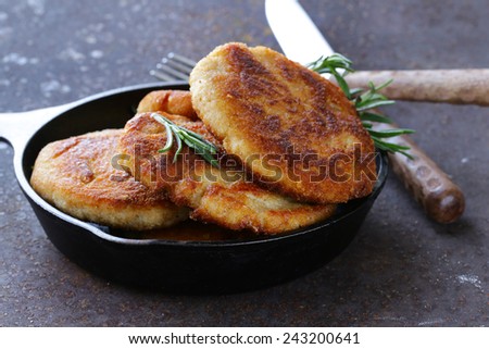 roasted meat burgers with rosemary in a pan