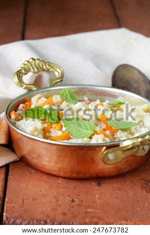 rice with vegetables cooked in Indian style in a copper pan