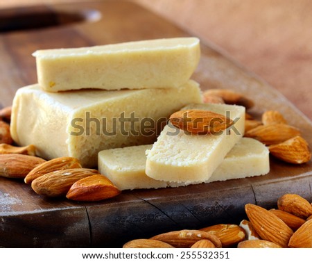 Marzipan almonds bar  bread , wish fresh almond on a wooden board