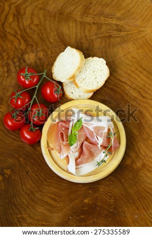 parma ham (jamon) with fragrant herbs traditional Italian meat appetizer