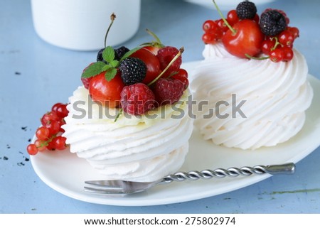 meringue dessert pavlova cake with berries and  butter cream