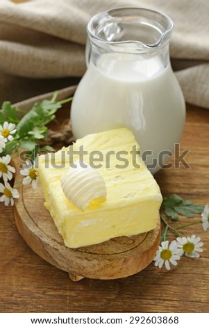 fresh yellow butter with a jug of milk, rustic still life