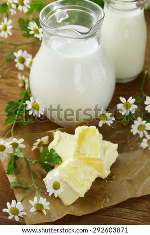 fresh yellow butter with a jug of milk, rustic still life