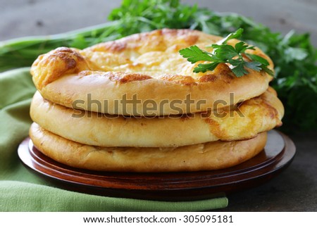 baked flat bread with cheese on a wooden table
