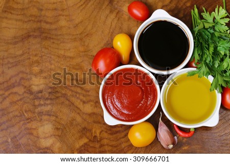 traditional Italian sauces - balsamic vinegar, tomato sauce and olive oil