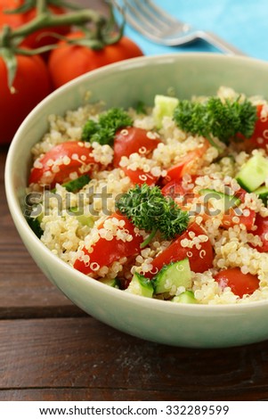Quinoa salad with cucumber and tomato in a bowl