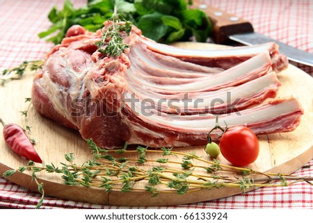 Lamb meat cut into steaks on wooden board