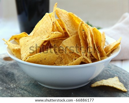 Mexican corn chips in a white cup