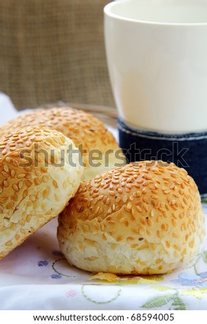 fresh rolls with sesame seeds and a glass of milk breakfast