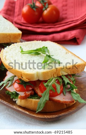 Sandwich with ham and fresh vegetables on the board