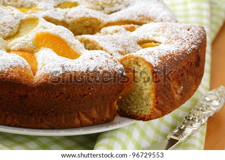 homemade ??pie with peaches, sprinkled with  powdered sugar