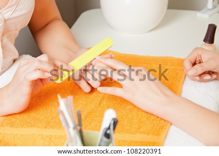 closeup picture of manicure process on female hands