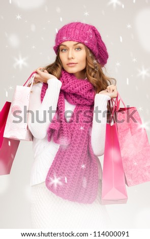 lovely woman with shopping bags over white.
