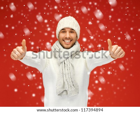 picture of handsome man in warm sweater with snow