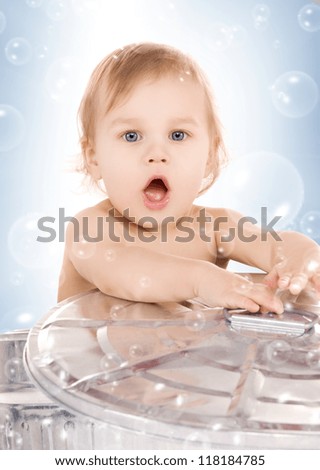 picture of adorable baby in can with soap bubbles