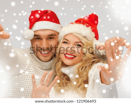 picture of family couple in sweaters and santa's hats