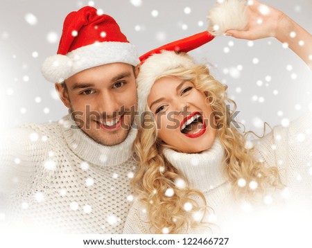 picture of family couple in sweaters and santa\'s hats